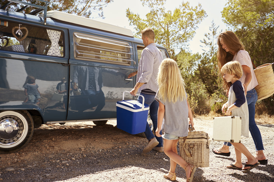 Parents and two young children on a family road trip together for summer vacation